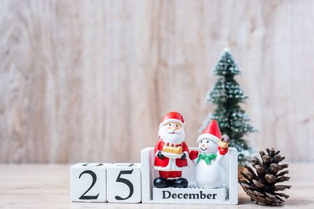 25 December calendar with Christmas decoration, snowman, Santa claus and pine tree  on wooden table background, preparation for holiday, Happy New Year and Xmas Conceptの写真素材
