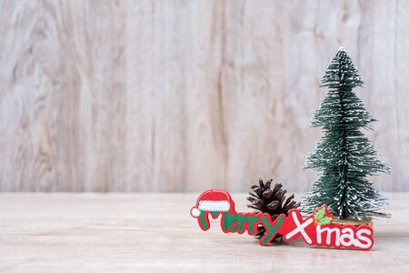 Christmas decoration, snowman, Santa claus and pine tree  on wooden table background, preparation for holiday, Happy New Year and Xmas Conceptの写真素材