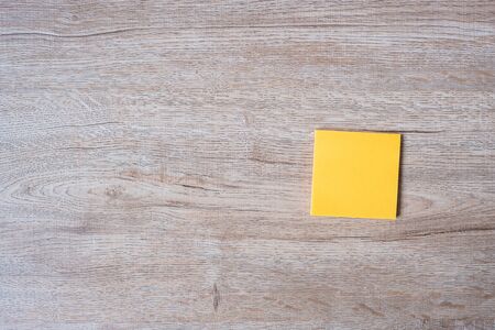 blank yellow note on wooden table background. Strategy, mission, vision and Goal conceptの写真素材
