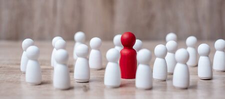 red leader businessman with crowd of wooden employees. leadership, business, team, teamwork and Human resource management conceptの写真素材