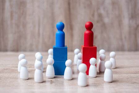 Red and Blue businessman leader  with crowd of wooden employee. leadership, business, team, teamwork and fighting conceptの写真素材