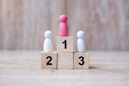 pink lady woman wooden stand on a top of state or the winner. People, Business, Successful and Victory Conceptsの写真素材
