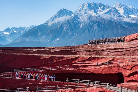 Impression of Lijiang (China outdoor theatre) against Jade Dragon Snow Mountain, is a performance demonstrating the tradition and lifestyle local ethnic people.Lijiang, Yunnan, China, 6 December 2019のeditorial素材