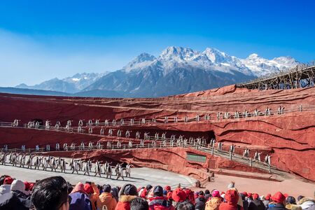 Impression of Lijiang (China outdoor theatre) against Jade Dragon Snow Mountain, is a performance demonstrating the tradition and lifestyle local ethnic people.Lijiang, Yunnan, China, 6 December 2019のeditorial素材
