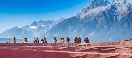 Impression of Lijiang (China outdoor theatre) against Jade Dragon Snow Mountain, is a performance demonstrating the tradition and lifestyle local ethnic people.Lijiang, Yunnan, China, 6 December 2019のeditorial素材
