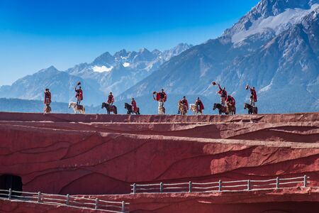 Impression of Lijiang (China outdoor theatre) against Jade Dragon Snow Mountain, is a performance demonstrating the tradition and lifestyle local ethnic people.Lijiang, Yunnan, China, 6 December 2019のeditorial素材
