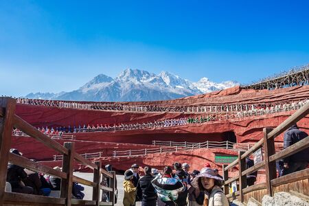 Impression of Lijiang (China outdoor theatre) against Jade Dragon Snow Mountain, is a performance demonstrating the tradition and lifestyle local ethnic people.Lijiang, Yunnan, China, 6 December 2019のeditorial素材