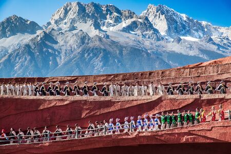 Impression of Lijiang (China outdoor theatre) against Jade Dragon Snow Mountain, is a performance demonstrating the tradition and lifestyle local ethnic people.Lijiang, Yunnan, China, 6 December 2019のeditorial素材