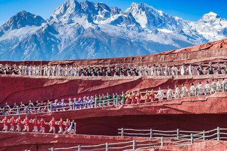 Impression of Lijiang (China outdoor theatre) against Jade Dragon Snow Mountain, is a performance demonstrating the tradition and lifestyle local ethnic people.Lijiang, Yunnan, China, 6 December 2019のeditorial素材
