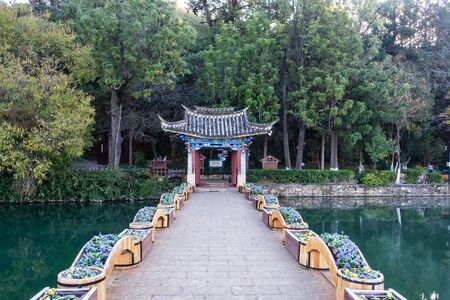 Beautiful of Black Dragon Pool with Jade Dragon Snow Mountain background, landmark and popular spot for tourists attractions near Lijiang Old Town. Lijiang, Yunnan, Chinaのeditorial素材