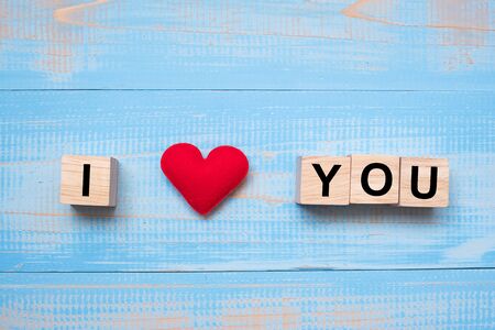 I LOVE YOU wooden cubes with red heart shape decoration on blue table background and copy space for text. Love, Romantic and Happy Valentineâs day holiday conceptの写真素材
