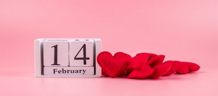 Red heart shape decoration with 14 February calendar on pink background. Love, Wedding, Romantic and Happy Valentine day holiday conceptの写真素材