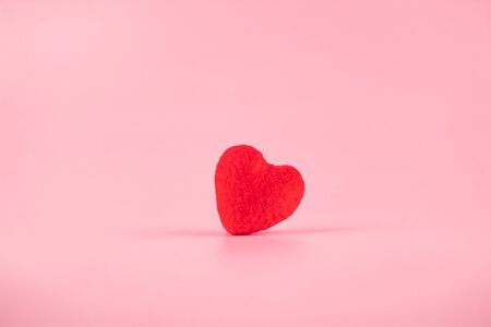 Red heart shape decoration with copy space for text on pink background. Love, Wedding, Romantic and Happy Valentine day holiday conceptの写真素材