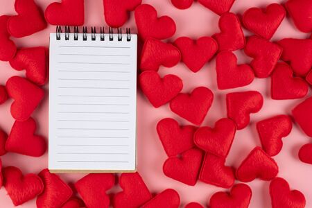 Red heart shape decoration with paper note on pink background. Love, Wedding, Romantic and Happy Valentine day holiday conceptの写真素材