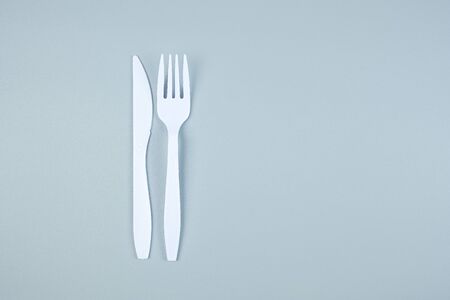 White plastic fork and knife on gray background with Copy space for text. Environmental Protection, Zero waste, Reusable, Say No Plastic, World Environment day and Earth day conceptの写真素材