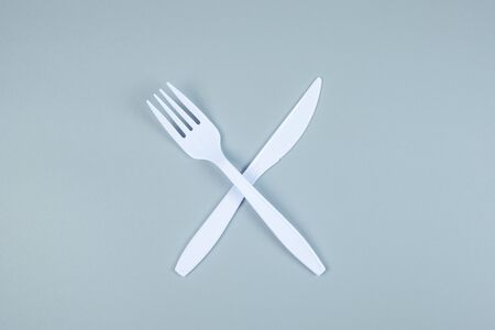 White plastic fork and knife on gray background with Copy space for text. Environmental Protection, Zero waste, Reusable, Say No Plastic, World Environment day and Earth day conceptの写真素材