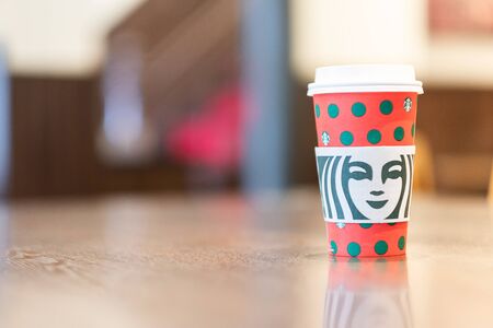hot Starbucks coffee paper cup on wooden table, for Christmas and 2020 Happy New Year collection. Kobe, Hyogo, Japan - November 28, 2019のeditorial素材