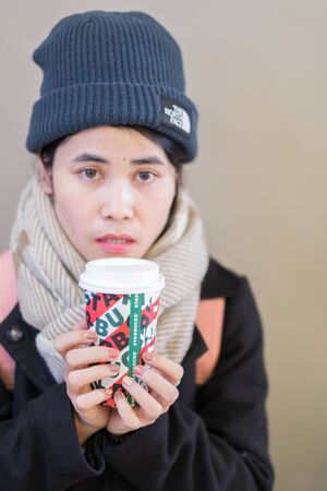 Woman hands holding hot Starbucks coffee paper cup, for Christmas and 2020 Happy New Year collection. Osaka, Japan - November 28, 2019のeditorial素材
