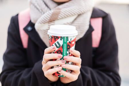 Woman hands holding hot Starbucks coffee paper cup, for Christmas and 2020 Happy New Year collection. Osaka, Japan- November 28, 2019のeditorial素材