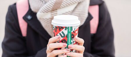 Woman hands holding hot Starbucks coffee paper cup, for Christmas and 2020 Happy New Year collection. Osaka, Japan - November 28, 2019のeditorial素材