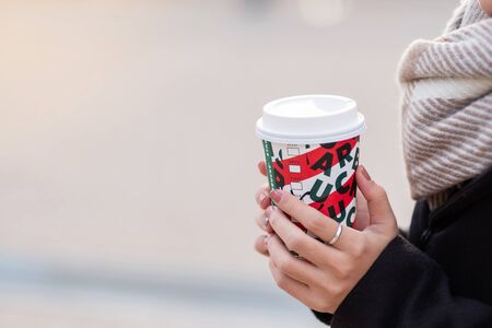 Woman hands holding hot Starbucks coffee paper cup, for Christmas and 2020 Happy New Year collection. Osaka, Japan - November 28, 2019のeditorial素材
