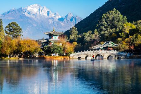 Beautiful of Black Dragon Pool with Jade Dragon Snow Mountain background, landmark and popular spot for tourists attractions near Lijiang Old Town. Lijiang, Yunnan, Chinaのeditorial素材