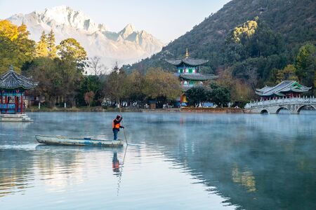 Beautiful of Black Dragon Pool with Jade Dragon Snow Mountain background, landmark and popular spot for tourists attractions near Lijiang Old Town. Lijiang, Yunnan, Chinaのeditorial素材