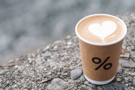 Latte coffee paper cup against river background in front  of % Arabica coffee shop, is a famous and popular for tourists attraction in Arashiyama. Arashiyama, Kyoto, Japan, 25 November 2019のeditorial素材
