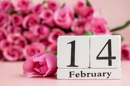 Pink rose flower and 14th February Calendar on pink background. Love, Romantic and Happy Valentines day Holiday conceptの写真素材