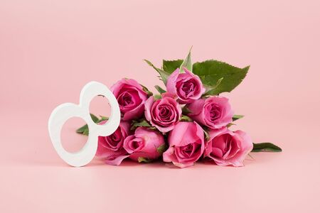 Pink Rose flower and 8th Number on pink background with copy space for text. Love, Equal and International Women day conceptの写真素材