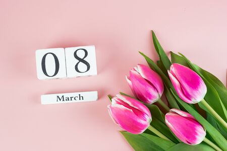 Pink Tulip flower and 8th March on pink background with copy space for text. Love, Equal and...