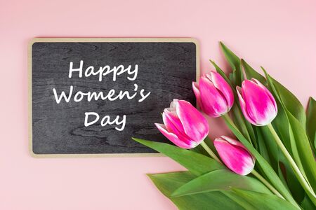 Pink tulip flower on blue wood table background with copy space for text. Love, International Women day, Mother day and Happy Valentine day conceptの写真素材