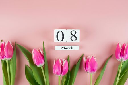 Pink Tulip flower and 8th March on pink background with copy space for text. Love, Equal and International Women day conceptの写真素材