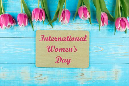 Pink tulip flower on blue wood table background with copy space for text. Love, International Women dayの写真素材