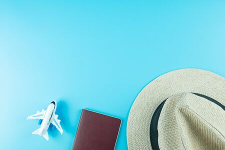 Top view Hat, Passport and Plane model on blue background with copy space for text. Travel and Vacation conceptの写真素材