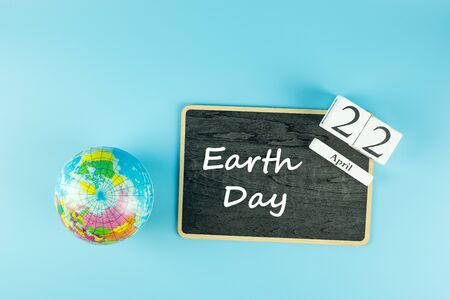 Globe and 22th April calendar on blue background. Happy Earth Day and environment conceptの写真素材