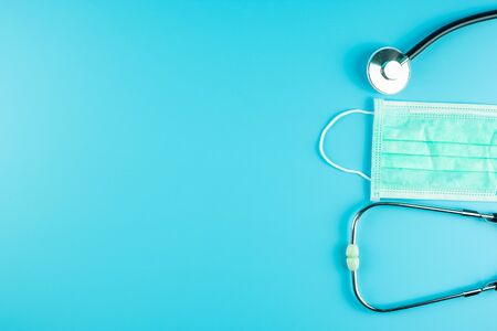 Top view Protective face mask and Stethoscope on blue background with copy space for text. Protection of Coronavirus , Covid-19 and Influenza. Antiseptic, World Health day and Happy Doctor day conceptの写真素材