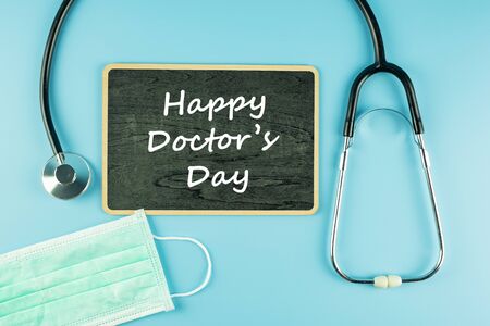 Top view Protective face mask and Stethoscope on blue background with copy space for text. Protection of Coronavirus , Covid-19 and Influenza. Antiseptic, World Health day and Happy Doctor day conceptの写真素材