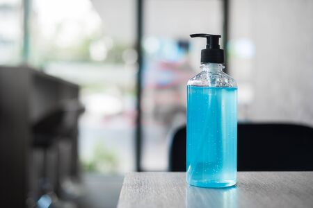 wash hand sanitizer gel bottle against Novel coronavirus or Corona Virus Disease (Covid-19) at office Indoor. Antiseptic, Hygiene and Healthcare conceptの写真素材