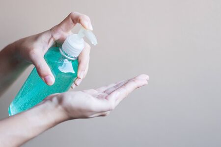 man hand using wash hand sanitizer gel dispenser, against Novel coronavirus or Corona Virus Disease (Covid-19) at public Indoor. Antiseptic, Hygiene and Healthcare conceptの写真素材