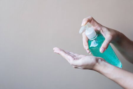 man hand using wash hand sanitizer gel dispenser, against Novel coronavirus or Corona Virus Disease (Covid-19) at public Indoor. Antiseptic, Hygiene and Healthcare conceptの写真素材