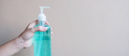 man hand using wash hand sanitizer gel dispenser, against Novel coronavirus or Corona Virus Disease (Covid-19) at public Indoor. Antiseptic, Hygiene and Healthcare conceptの写真素材