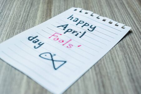 white paper note with the text April Fools day on wood tableの写真素材