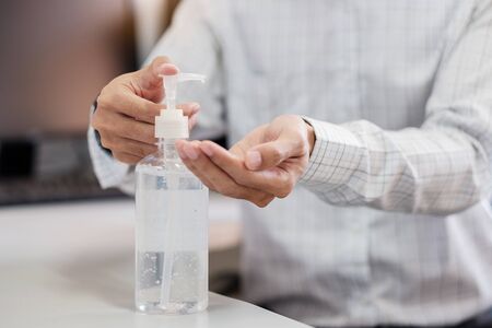Man hands using wash hand alcohol gel or sanitizer bottle dispenser, against Novel coronavirus or Corona Virus Disease (Covid-19) . Antiseptic, Hygiene and Health conceptの写真素材