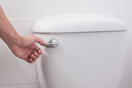 hand press and flush toilet. Cleaning, Lifestyle and personal hygiene conceptの写真素材