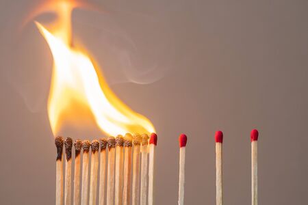 matchsticks burning and gap distance showing preventative containing coronavirus pandemic with copy space for text. Stay at home, Quarantines and Social Distancing conceptの写真素材
