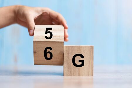 Businessman hand change wooden block from 5G to 6G (Generation of Cellular Mobile Communications)...