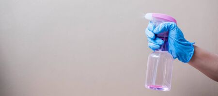 Man spraying disinfectant bottle, prevent coronavirus or Corona Virus Disease (Covid-19) at office...