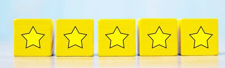 wooden blocks with the star symbol. Customer reviews, feedback, rating, ranking and service concept.の写真素材