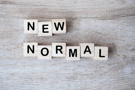 NEW NORMAL cube blocks on table background, the end of Coronavirus pandemic. Human lifestyle Behavior will change such as using face mask, personal hygiene, Work from Home and Social distancingの写真素材